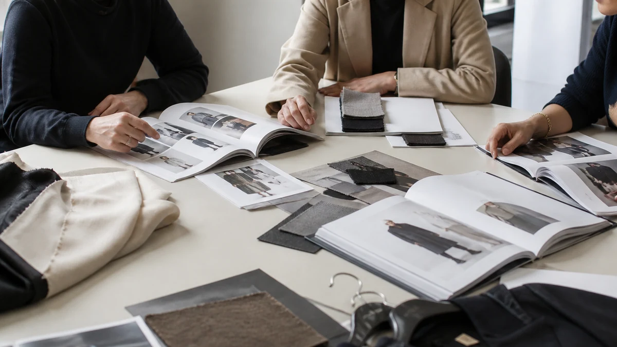 Fashion buying meeting with lookbooks and fabric samples
